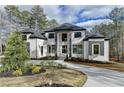 An eye-catching two-story home with custom landscaping, lush yard, and circular driveway at 4090 Sandy Lake Dr, Stonecrest, GA 30038