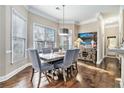 Charming dining room with hardwood floors, picture window, and stylish furnishings at 1120 Constitution Way, Cumming, GA 30040