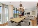 Elegant dining area featuring a modern chandelier, large windows, and city views at 750 Park Ne Ave # 8E, Atlanta, GA 30326