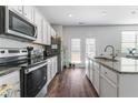 Modern kitchen with stainless steel appliances and granite countertops at 248 Hamilton Pointe Dr, Mcdonough, GA 30253