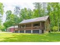 Rustic log cabin with a wraparound porch and a large yard at 58 Wesley Chapel Ln, Villa Rica, GA 30180