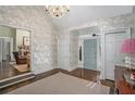 Bright entryway with hardwood floors, decorative wallpaper, and view of living room at 1225 W Wesley Nw Rd, Atlanta, GA 30327