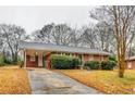 Brick ranch house with carport and mature trees at 4685 Ruby Ln, Forest Park, GA 30297