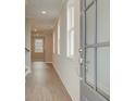 Light and bright entryway with hardwood floors and gray door at 200 Dahlia Dr, Woodstock, GA 30188