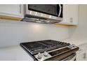 Close-up of gas cooktop and white hexagonal backsplash at 200 Dahlia Dr, Woodstock, GA 30188