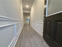 Bright hallway with gray flooring and wainscoting at 5415 Rock Place Ct # 36, Norcross, GA 30093