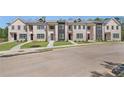 Brick townhomes offering manicured landscaping and convenient paved walkways at 165 Brush Creek Ct, Hampton, GA 30281