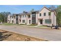 Brick townhomes featuring manicured lawns and convenient street access at 165 Brush Creek Ct, Hampton, GA 30281