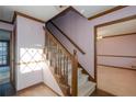 Wooden staircase with carpeted steps and wooden railings at 714 Lanford Springs Sw Dr, Lilburn, GA 30047