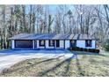 Ranch style home with attached two-car garage and landscaped yard at 1900 Mornington Ln, Snellville, GA 30078