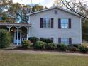 Charming two-story home with stone accents, fresh landscaping, and a welcoming front porch at 3648 E Melissa Ln, Douglasville, GA 30135
