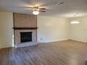 Spacious living room featuring hardwood floors, a fireplace, and ample natural light at 3648 E Melissa Ln, Douglasville, GA 30135