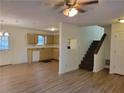 Open-concept living space with kitchen view, new flooring, and staircase access at 3648 E Melissa Ln, Douglasville, GA 30135