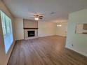 Bright living room with a stone fireplace, laminate floors, a ceiling fan and ample natural light at 3648 E Melissa Ln, Douglasville, GA 30135