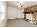 Living room with stone fireplace and ceiling fan at 3762 Elkridge Dr, Decatur, GA 30032