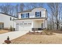 Two-story house with white siding, a gray stone base, and a two-car garage at 4745 Marjorie Dr, Cumming, GA 30041