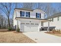 Two-story house with white siding, a gray stone base, and a two-car garage at 4745 Marjorie Dr, Cumming, GA 30041