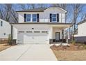 Two-story house with white siding, a gray stone base, and a two-car garage at 4745 Marjorie Dr, Cumming, GA 30041