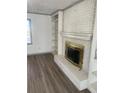 White brick fireplace with gold-toned surround in living room at 1678 Se Christian Cir, Conyers, GA 30013