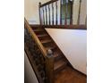 Wooden staircase with brown carpeting and wooden railing at 4681 Mercer Rd, Stone Mountain, GA 30083