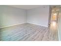 Spacious living room featuring light gray walls and wood-look flooring at 1818 Ashborough Cir # E, Marietta, GA 30067