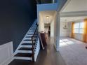 Inviting entryway with hardwood floors, stairs, and views into the carpeted living room at 330 Piedmont Cir, Covington, GA 30016