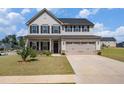 Charming two-story home featuring a two-car garage, covered porch, and well-maintained lawn at 467 Daffodil Ln, Mcdonough, GA 30253