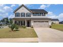 Beautiful two-story home featuring a two-car garage and a well-manicured lawn at 467 Daffodil Ln, Mcdonough, GA 30253