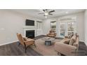 Bright living room with a fireplace, built-in shelving, and stylish furnishings at 4145 Essex Pond Way, Cumming, GA 30040