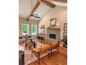 Inviting living room featuring high ceilings, wooden beams, and a cozy fireplace at 101 Red Oak Ln, Carrollton, GA 30116