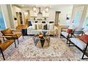 Bright living room featuring an open floor plan and stylish furniture with view into the kitchen and island at 101 Red Oak Ln, Carrollton, GA 30116