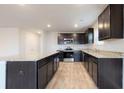 Kitchen with granite counters, stainless steel appliances, and dark cabinets at 620 Egrets Landing Lot #68 Lndg, Covington, GA 30014
