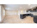 Open-concept kitchen with island, stainless steel appliances, and wood flooring at 620 Egrets Landing Lot #68 Lndg, Covington, GA 30014