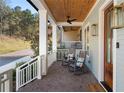 Inviting front porch with rocking chairs and a wooden ceiling, perfect for relaxing outdoors at 1130 Lupo Loop, Chattahoochee Hills, GA 30268