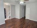 An inviting living room featuring beautiful laminate flooring and a neutral color palette at 2438 Brianna Dr, Hampton, GA 30228