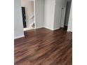An open-concept living room with laminate floors, freshly painted walls, and abundant natural light at 2438 Brianna Dr, Hampton, GA 30228