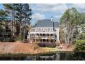 Rear view of a beautiful brick home with a large deck overlooking the lake at 6191 Talmadge Run, Acworth, GA 30101