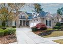 Beautiful brick home with a well-manicured lawn, black shutters, and a three car garage at 6191 Talmadge Run, Acworth, GA 30101