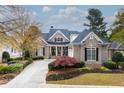 Charming brick home with well-manicured landscaping and a paved driveway at 6191 Talmadge Run, Acworth, GA 30101