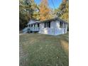 Side view of a white house with gray steps and a grassy yard at 175 Smith Ferguson Rd, Dallas, GA 30157