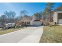 House exterior showcasing a large driveway and surrounding landscape at 4706 Warrior Se Way, Mableton, GA 30126