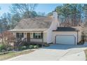 Charming ranch home with a spacious driveway and mature trees at 4706 Warrior Se Way, Mableton, GA 30126