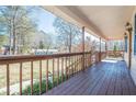 Inviting front porch with wooden flooring and a swing overlooking the yard at 4706 Warrior Se Way, Mableton, GA 30126