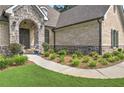Inviting front entrance with stone archway, detailed brickwork, and manicured landscaping at 1560 Tapestry Rdg, Lawrenceville, GA 30045
