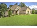 Beautiful brick home featuring manicured landscaping and a well-maintained lawn at 1560 Tapestry Rdg, Lawrenceville, GA 30045