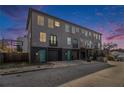 Three-story townhome featuring gray siding, black brick accents, and teal doors and balcony trim at 93 Terry Se St # A, Atlanta, GA 30312