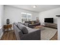 Living room with gray sofas, wood coffee table, and large TV at 93 Terry Se St # A, Atlanta, GA 30312