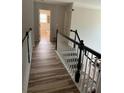 Bright hallway with wood floors and staircase leading to the second floor at 1074 Bradshaw Estates Dr, Canton, GA 30115
