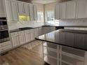 Modern kitchen featuring white cabinets, granite countertops, and stainless steel appliances at 1074 Bradshaw Estates Dr, Canton, GA 30115