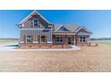 This craftsman-style home has a brick-foundation, gray siding and wood-look shutters at 1422 Alcovy Station Rd, Covington, GA 30014